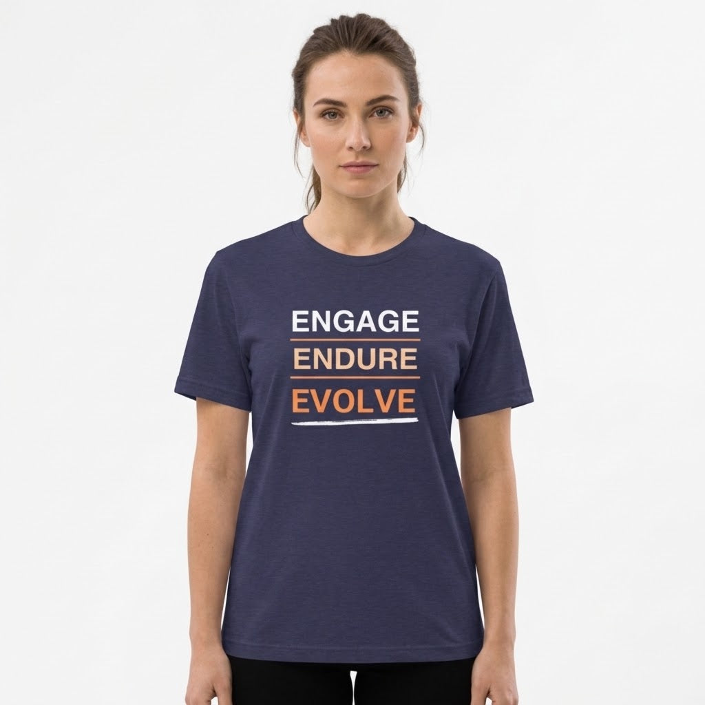A woman modeling a navy blue short-sleeve t-shirt with the words 'ENGAGE ENDURE EVOLVE' printed on the chest in white and orange.